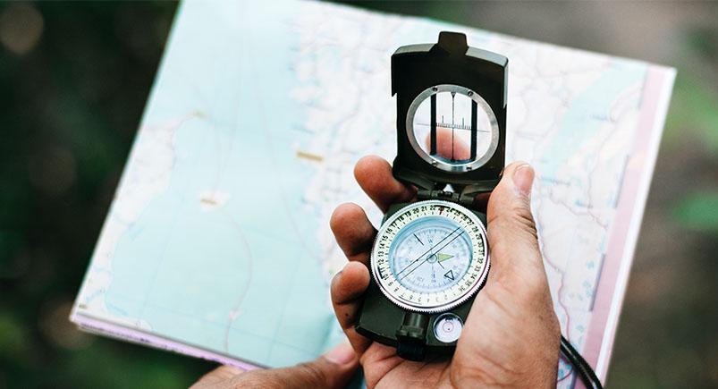 Person holding a compass