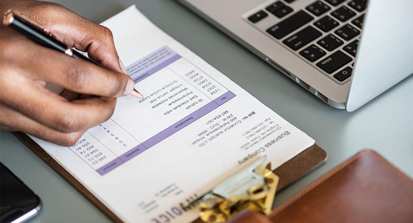 Employee filling out a paper document