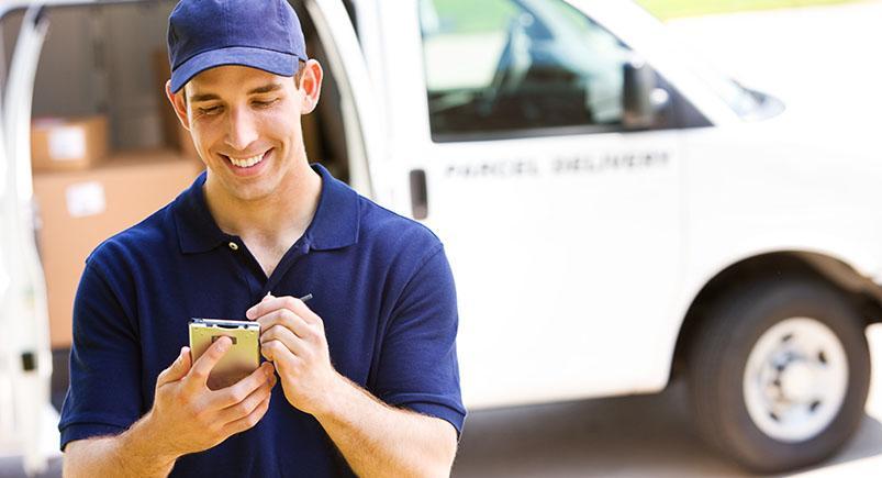 A courier employee completing a work order digitally