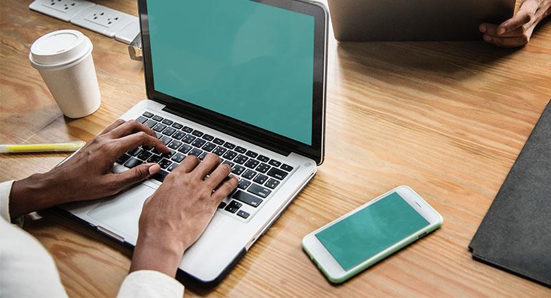 Employee logging on to a laptop computer