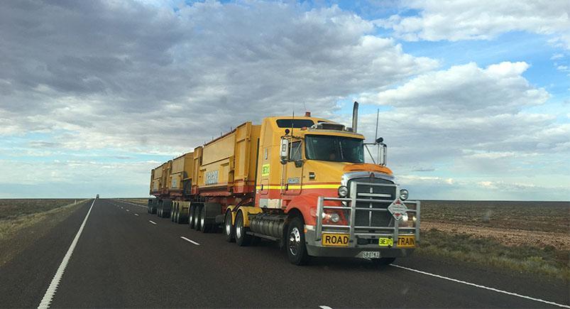 Semi truck driving down the road