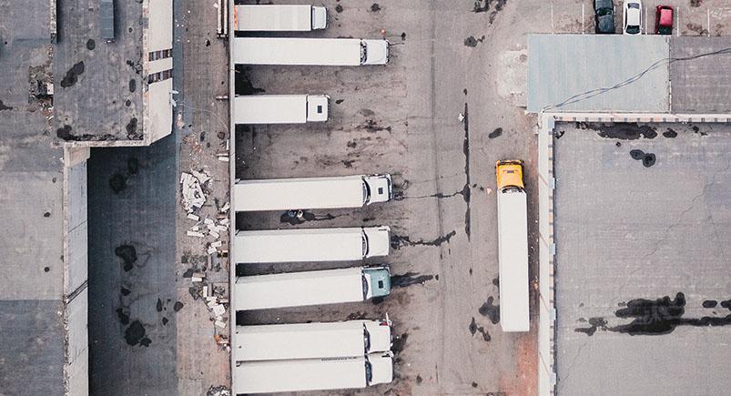 importance-trucking-industry_trucks-overhead_ivan-bandura A trucking company's warehouse