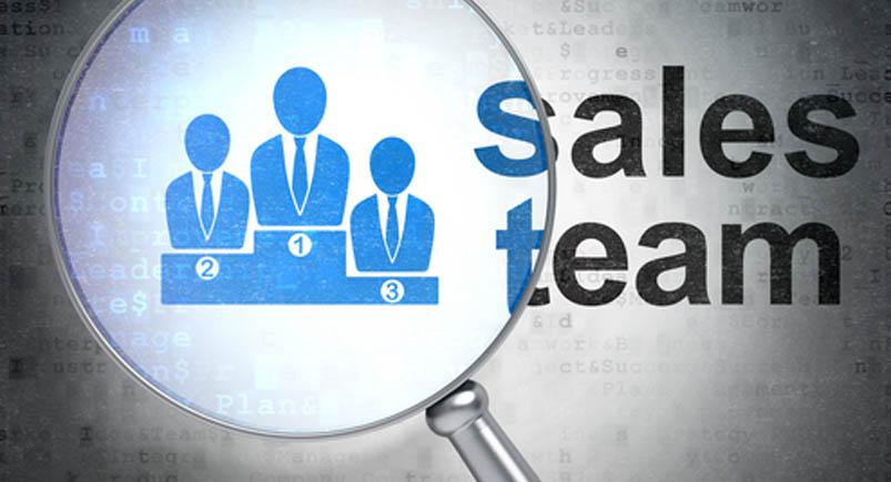 Sales team icons with a magnifying glass
