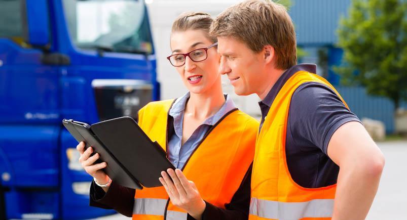 Forwarder in front of trucks on a depot Employees receiving dispatched work orders