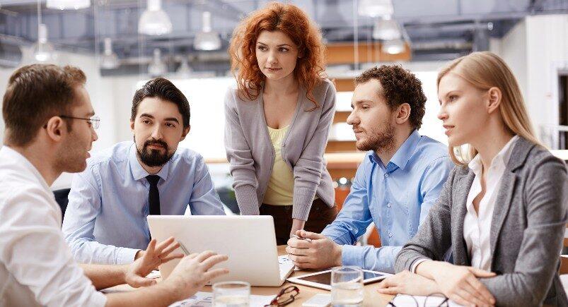 Employees from different departments communicating in a meeting