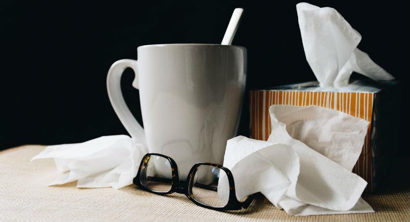 mug-tissues-preventing-flu A mug, glasses, and tissues on a desk