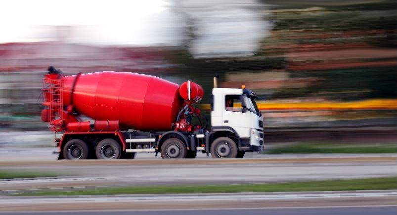 Cement truck driving down the road
