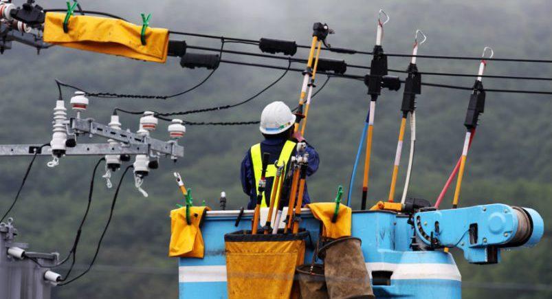 Utility worker repairing a power line