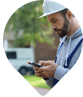 Field services contractor checking phone for job details through Mobile Workforce Management software