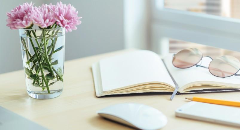 Book and reading glasses on a desk