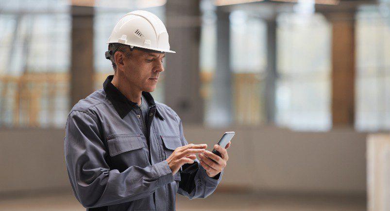 Construction manager distributing new work orders digitally