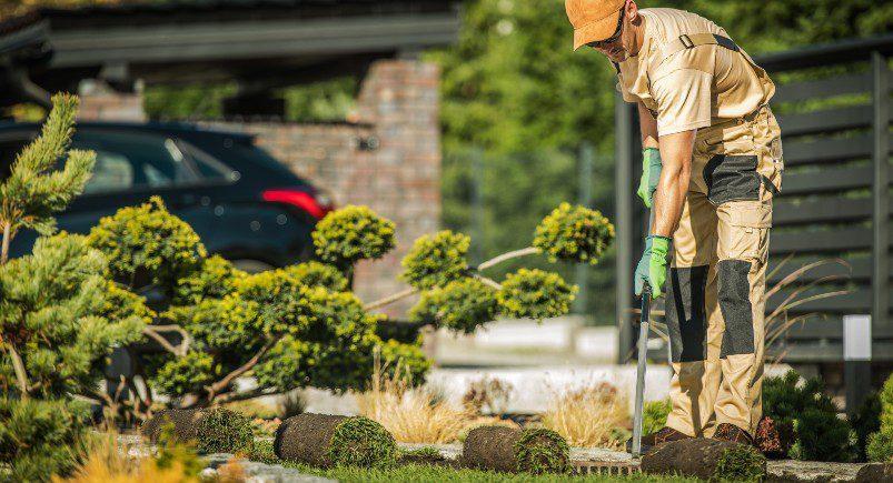 Landscaping employee unfurling sod Landscaping companies can rely on Mobile Workforce Management software to empower their business