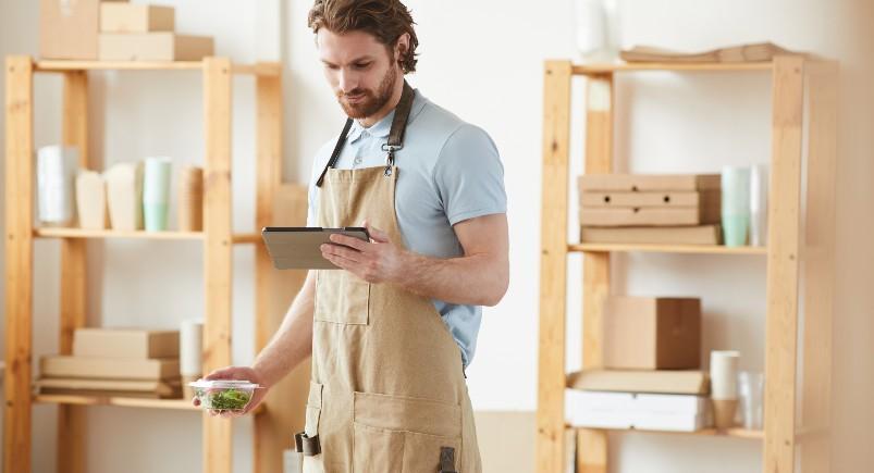 Worker completing digital forms for his business