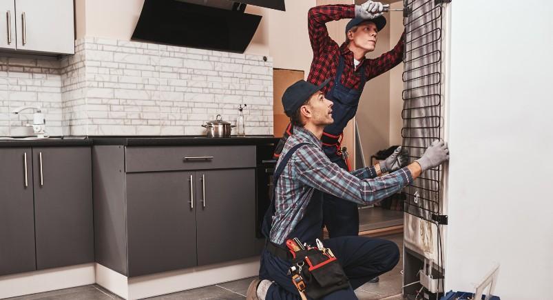 Refrigerator repair technicians working