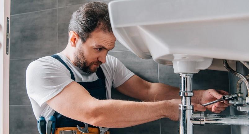 Plumber fixing sink