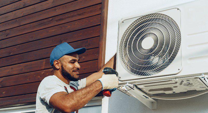 HVAC technician installing A/C unit