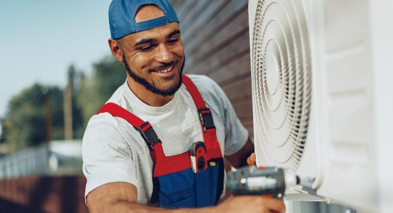 HVAC technician working on A/C unit with TeamWherx exporting accurate timekeeping information to office