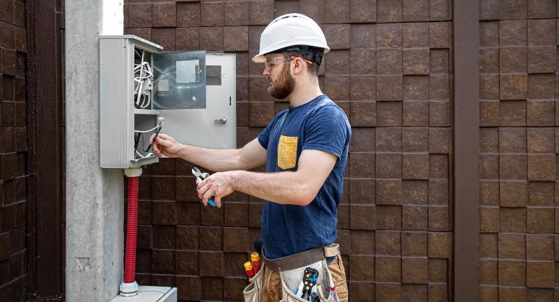 Electrician rewiring power box while working overtime, imported into QuickBooks Online via Mobile Workforce Plus