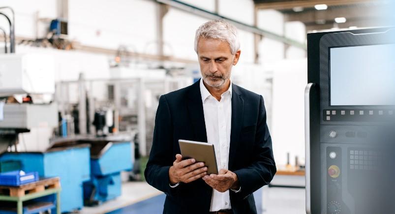 Businessman using a mobile workforce management solution