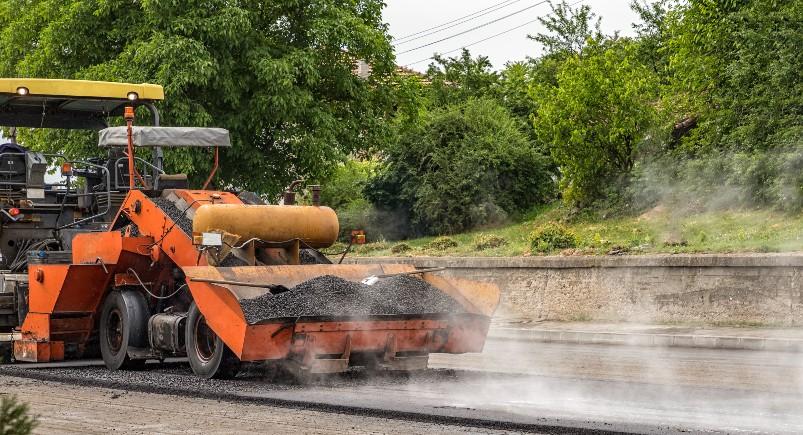 Paving company pouring asphalt