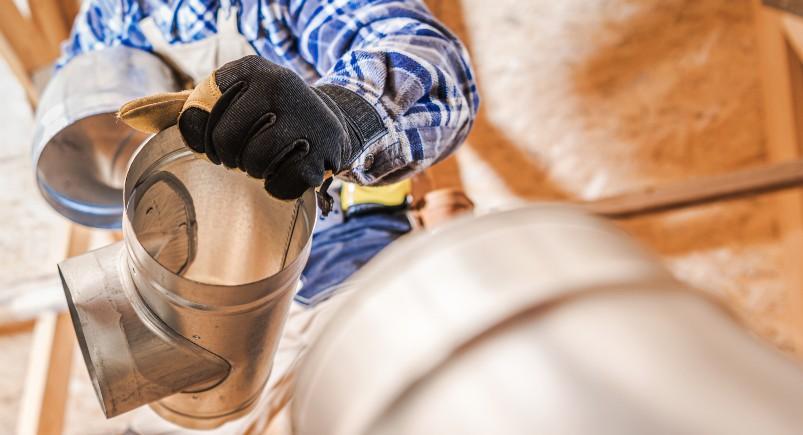 HVAC technician installing ventilation