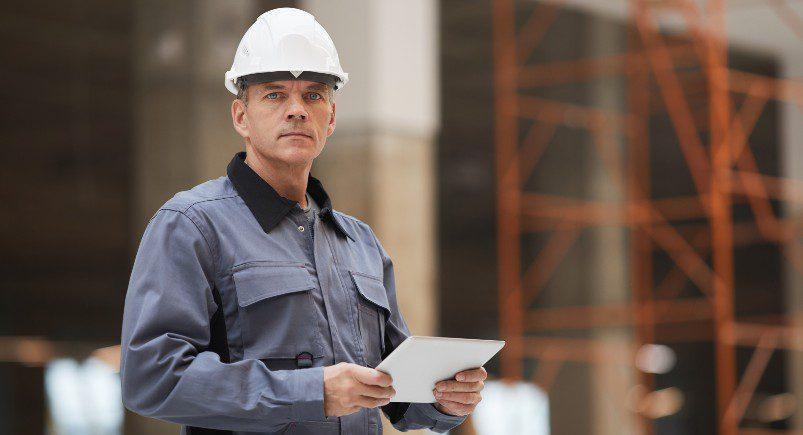 Construction supervisor verifying OSHA compliance