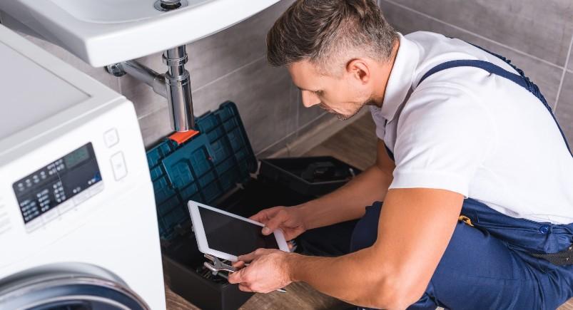 Plumber completing a work order digitally