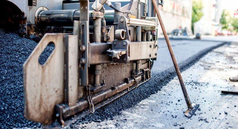 Concrete and asphalt contractor paving a new road