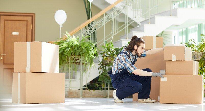 Moving company employee unpacking boxes