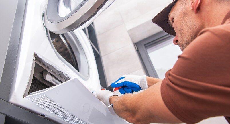 An appliance repair specialist fixing a washing machine