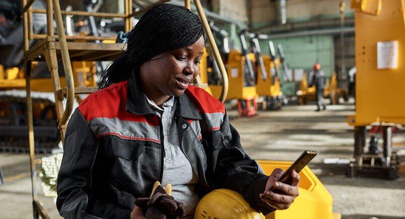 An employee using field service management software on a mobile device