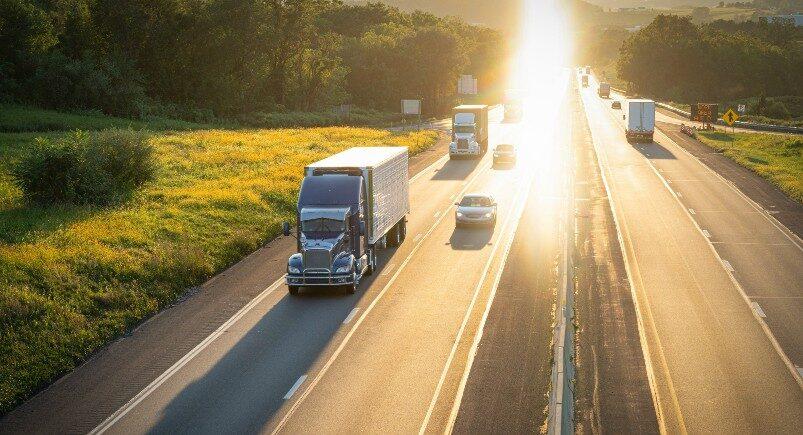 A freight company truck driving down the interstate