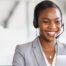 A businesswoman receiving client feedback from a customer over the phone