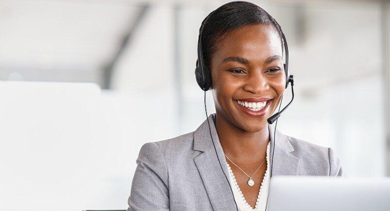 A businesswoman receiving client feedback from a customer over the phone